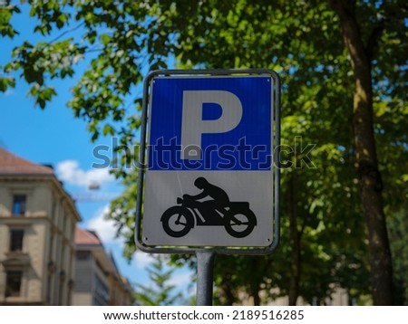 Sign for a motorcycle parking area over city street Basel.