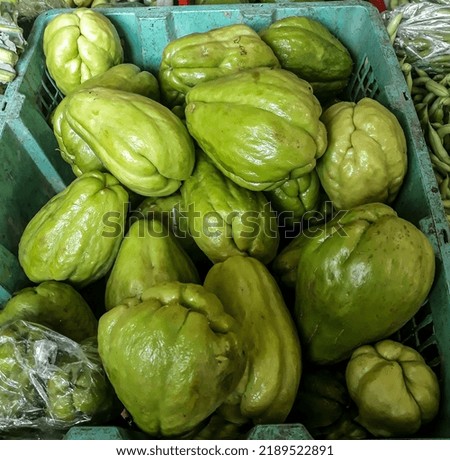 Piles are a fresh chayote on sale in the market, taken from a near angle