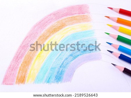 Rainbow drawing on paper with colored pencils. Art classes