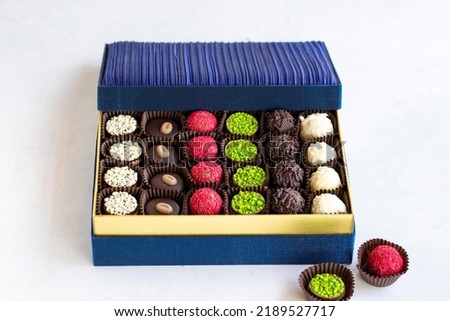Packed chocolate. Assortment of packed truffle chocolates on a white background. close up