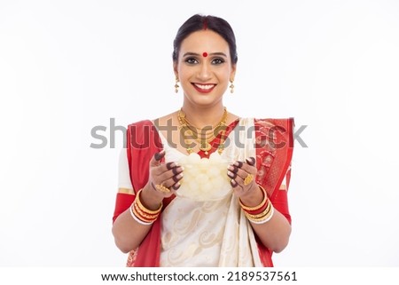 Happy woman holding bowl of fresh bengali sweet rasgulla 
 Royalty-Free Stock Photo #2189537561
