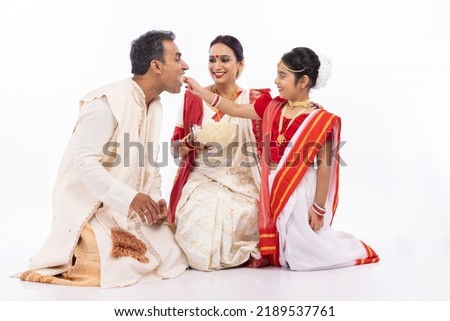 Happy mother with daughter feeding fresh bengali sweet rasgulla to her father
 Royalty-Free Stock Photo #2189537761