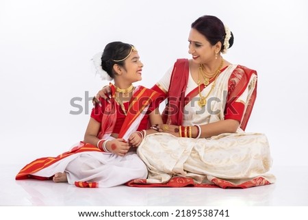 Happy bengali mother and daughter spending leisure time together in traditional clothing
 Royalty-Free Stock Photo #2189538741