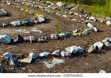Lines of stones laid out on the ground. High quality photo
