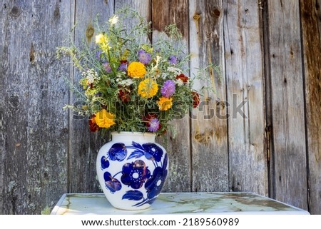 Field and decorative flowers in a vase