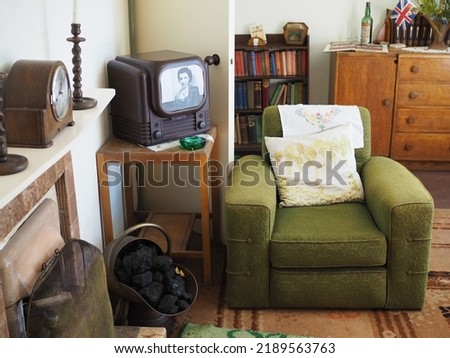 Living room in prefabricated building with nineteen forties or fifties furniture of fitting. Green armchair and small tv.       Royalty-Free Stock Photo #2189563763
