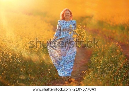 sunny summer in the field girl in a dress, beautiful young woman enjoys a dream