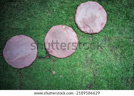Top view group of sand stones in round shape place on the lawn field at the outdoor garden Royalty-Free Stock Photo #2189586629