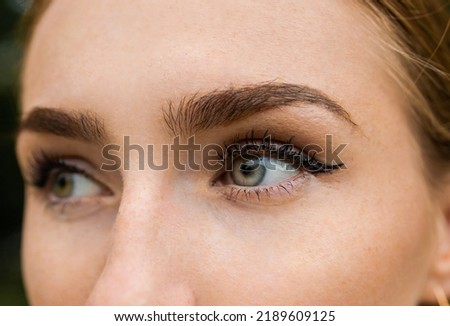 Close-up portrait of a beautiful girl with blue eyes, bushy eyebrows and arrows.  Royalty-Free Stock Photo #2189609125
