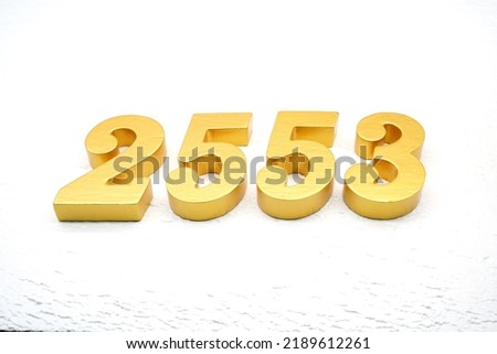    Number 2553 is made of gold painted teak, 1 cm thick, laid on a white painted aerated brick floor, visualized in 3D.                               