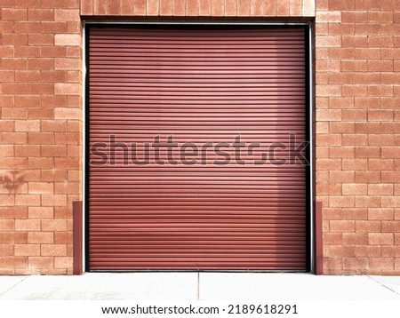 a warehouse roll up door loading dock garage brick alley building street carport Royalty-Free Stock Photo #2189618291