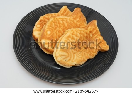 Sweet red bean bread in the shape of a crucian carp in a bowl Royalty-Free Stock Photo #2189642579