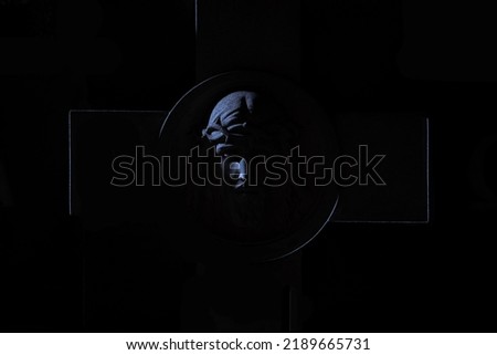 Christianity sign cross and Jesus face sculpture silhouette in darkness black background religion concept picture 