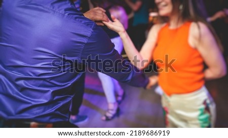 Couples dancing traditional latin argentinian dance milonga in the ballroom, tango salsa bachata kizomba lesson in the red and purple lights, dance festival
 Royalty-Free Stock Photo #2189686919