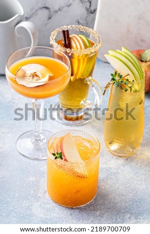 Variety of fall cocktails or mocktails made with apple cider in a light and bright setting, fall brunch drinks ideas