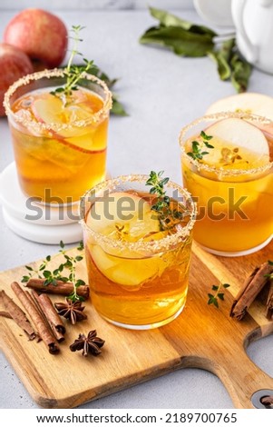 Hard apple cider cocktail with cinnamon and thyme, fall drink concept