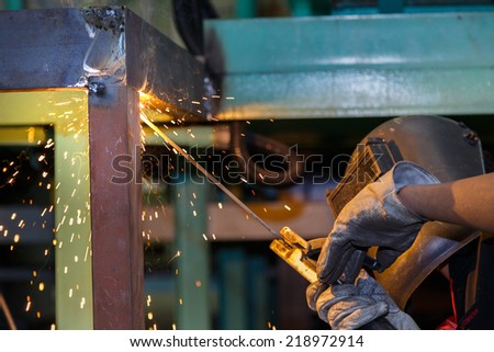 worker welding steel construction by electric welding