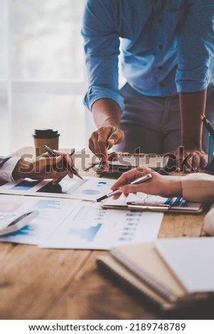 Financial analyst analyzes business finance reports on laptop and graph documents during corporate meeting discussions showing successful teamwork, business meeting ideas, marketing. Royalty-Free Stock Photo #2189748789