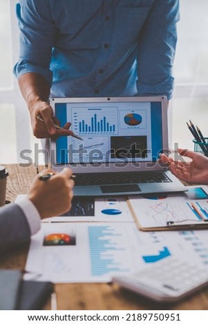 Financial analyst analyzes business finance reports on laptop and graph documents during corporate meeting discussions showing successful teamwork, business meeting ideas, marketing. Royalty-Free Stock Photo #2189750951