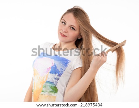 attractive blonde girl makes the hairstyle on white background