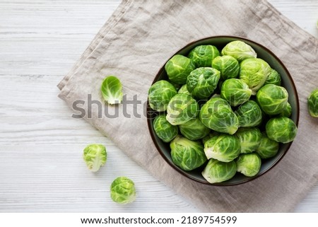 Raw Organic Brussel Sprouts in a Bowl, top view. Flat lay, overhead, from above. Copy space. Royalty-Free Stock Photo #2189754599