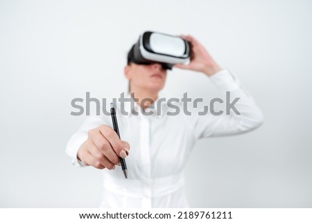 Woman Wearing Vr Glasses And Pointing On Recent Updates With Pen. Businesswoman Having Virtual Reality Eyeglasses And Presenting New Idea. Executive Showing Late Data.