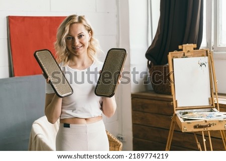 A woman holds boards with yoga nails in her hands. Spiritual practice in Zen Buddhism. Strengthening the spirit and mental health. Healing the body through the practice of standing on nails Royalty-Free Stock Photo #2189774219
