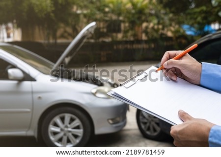 Insurance officer agent working during on site car accident claim process