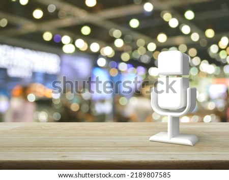 Microphone 3d icon on wooden table over blur light and shadow of shopping mall, Business communication concept