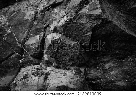  Black white rock texture. Rough mountain surface. Close-up. Dark stone basalt background with space for design. Blackdrop.                              