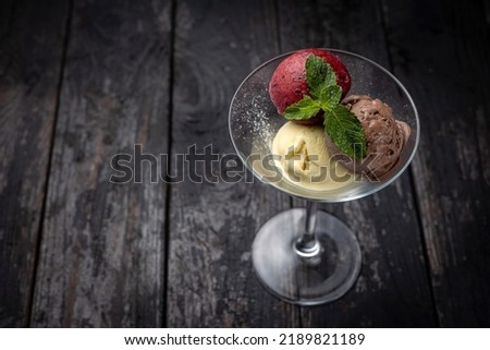ice cream with chocolate and mint on a wooden background.