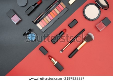 set decorative cosmetics on black and red background