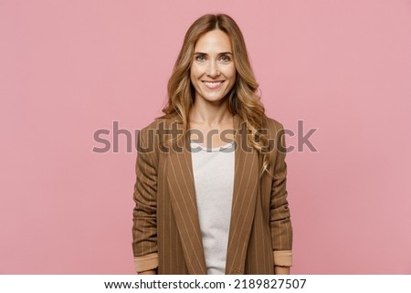 Young satisfied smiling happy fun cheerful successful european employee business woman 30s she wearing casual classic jacket look camera isolated on plain pastel light pink background studio portrait Royalty-Free Stock Photo #2189827507