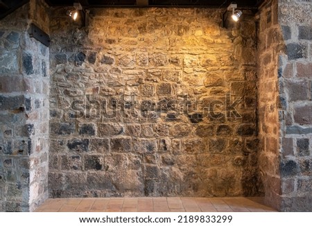 Stone wall of a church interior with spotlights illuminating