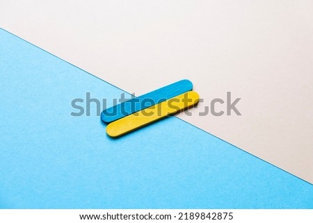 flag of ukraine on a blue and beige background. Flag made of colored wooden sticks
