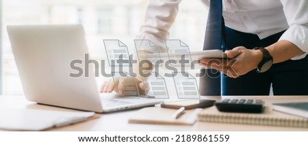 Businessman checking electronic document on a digital document on a virtual laptop computer screen,Paperless workplace idea, e-signing, electronic signature, document management.
