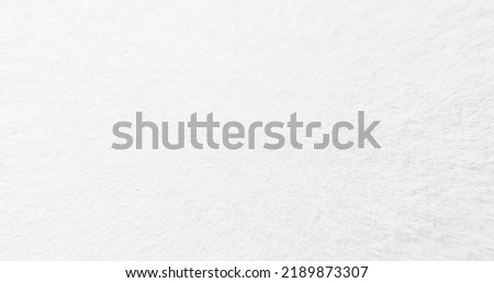 White textured paper for watercolor painting. Noise overlay. Light empty uneven grain wallpaper surface abstract copy space background.