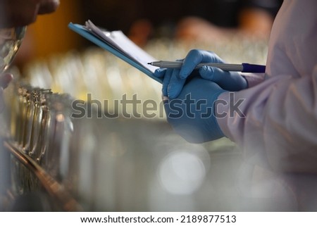 Factory worker inspecting production line of drink production in factory , Concept of food industry  Royalty-Free Stock Photo #2189877513
