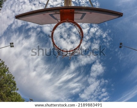 An iron outdoor basketball hoop with blue sky background in the sports field in Santo Tirso, Portugal.The basketball hoop or ring. Royalty-Free Stock Photo #2189883491
