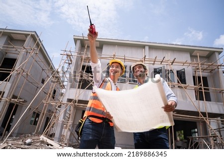 Mechanical Engineer team Working with paper work on construction home building site	 Royalty-Free Stock Photo #2189886345