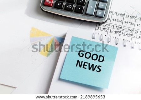 GOOD NEWS text on blue sticker card on notepad on office desk, business concept