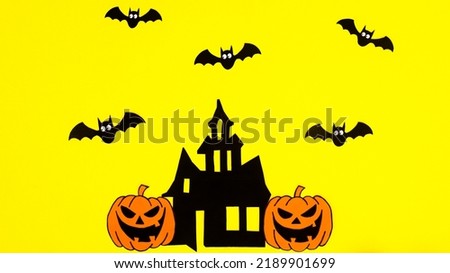 Yellow background with creative arrangement of creepy Halloween stickers. Copy space flat lay