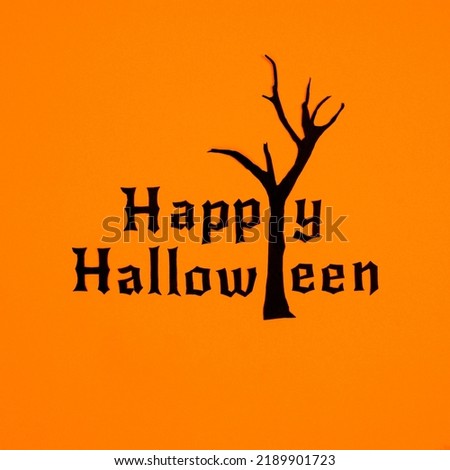 Happy Halloween background with creepy tree on orange background. Flat lay minimal concept. Autumn holidays