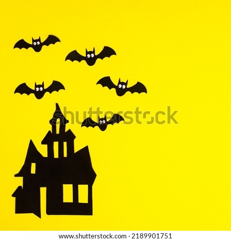 Creepy Horor house with bats on yellow background. Halloween holidays copy space background. Flat lay