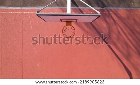 An iron outdoor basketball hoop with blue sky background in the sports field in Santo Tirso, Portugal. The basketball hoop or ring. Royalty-Free Stock Photo #2189905623