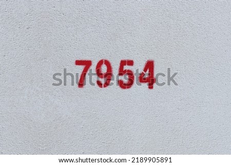 Red Number 7954 on the white wall. Spray paint.
