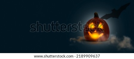 halloween party invitation card with bright Jack O'Lantern, isolated shiny pumpkin and schadow of bat on dark blue graphical background with copy space, abstract halloween concept banner