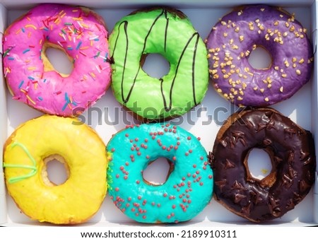 Donuts in cardboard packaging. Doughnuts set with sprinkles in paper box. Sweet snack, dessert, friedcake, pastry, yummy, coffee break Royalty-Free Stock Photo #2189910311