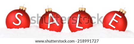 Sale concept. Beautiful red Christmas balls in snow isolated on white