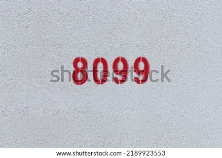 Red Number 8099 on the white wall. Spray paint.
